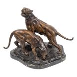 A bronze group of two tigers: mounted on a naturalistic base,