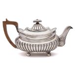 A George III silver teapot, Michael Starkey, London, 1809: crested,