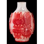 A Chinese Peking overlay glass snuff bottle: of oval form carved with auspicious objects,