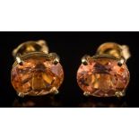 A pair of oval topaz single-stone ear-studs: each with an oval topaz approximately 9.2mm x 7.