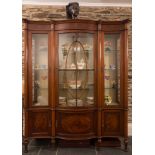 An Edwardian mahogany and inlaid serpentine fronted display cabinet:, bordered with boxwood lines,