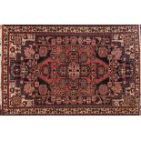 A Qashgai rug:, the shaded field with a brick red pointed medallion and geometric designs,