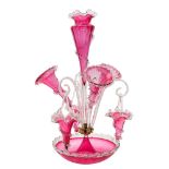 A cranberry glass table epergne: with central vase set in a circular bowl and flanked by three