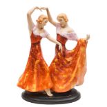 A Royal Dux Art Deco group of two Spanish dancers: in exotic pose and wearing pink trimmed red and