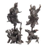 A pair of Chinese rootwood carvings depicting dancing figures: mounted on naturalistic stands,