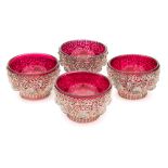 A set of four silver filigree salts: of circular outline with open trellis work of scrolls and