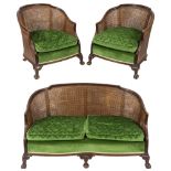 A 1920's carved walnut and beechwood three piece bergere suite:,