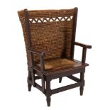 A child's Orkney Islands oak wing armchair:, with curved rope pattern back,