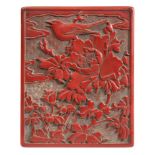 A Chinese cinnabar lacquer rectangular box and cover: the lid decorated with a bird perched amongst