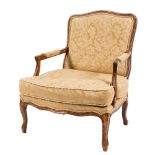 A French grained walnut open armchair in the Louis XV provincial taste:,