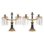A pair of Regency period gilt bronze twin-branch table lights: with urn-shaped nozzles,