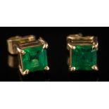 A pair of square emerald single-stone ear-studs: each with a square-cut emerald approximately 5mm