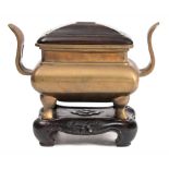 A Chinese polished bronze censer: of rectangular section with pierced curved handles and on