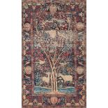 An Isfahan rug:, the indigo field with deer and with birds in a flowering tree,