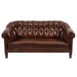 A Swedish Chesterfield style sofa:, fully upholstered in brown buttoned leather,