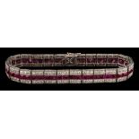 An early 20th century ruby and diamond line bracelet: with central row of calibre-cut rubies