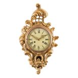 A carved giltwood cartel wall clock: of cartouche-shaped outline with pierced lattice,