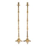A pair of 19th century brass floor standing candlesticks: with ring turned nozzles,