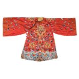 A Chinese embroidered silk court robe: decorated with dragons and bats amongst clouds,