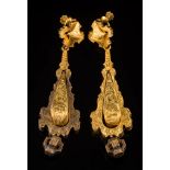 A pair of 19th century gold pendant drop earrings: each articulated pear-shaped drop with foliate