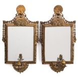 A pair of late 19th century gilt-brass girandole mirrors: each with peacock finial and single