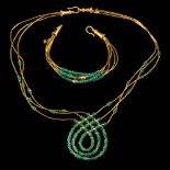 A Middle Eastern gold coloured bead and emerald bead necklace: with 'shepherd's crook' clasp and