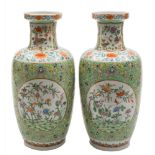 A pair of Chinese famille rose baluster vases: each painted with panels of auspicious objects, bats,