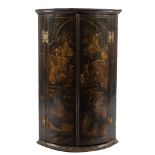 An 18th Century black lacquer and chinoiserie bow-fronted hanging corner cupboard:,