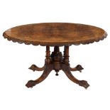 A Victorian carved walnut and inlaid oval breakfast table:,