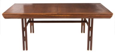 A 1960's teak rectangular extending dining table:, on propeller type legs united by stretchers,