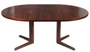 A 1960's teak circular extending dining table:, the top with a banded edge,
