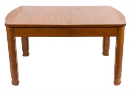 A 1930's Swedish oak dining table:, with curved ends and rounded legs,