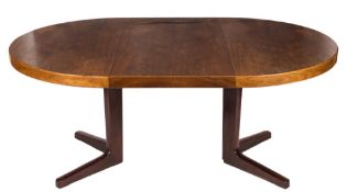 A 1960's teak and rosewood circular extending dining table:, on a central cruciform column and base,