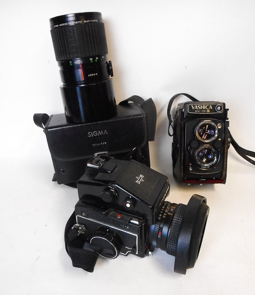 A Yashica Mat-124G twin lens reflex camera:, together with a Mamiya 645 camera with spare lens.