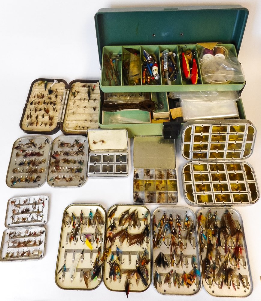 A collection of fly tins: containing wet and dry trout flies and lures, together with spinners,