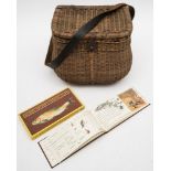 An early 20th century wicker creel/fishing seat:, with brown leather shoulder strap,