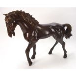 A 20th century bronze model of a stallion: unsigned, 58cm. long..