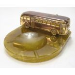 A mid-20th century gilt copper and onyx ashtray with a model of a coach:, 21cm wide.