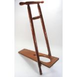 An early 20th century mahogany boot pull:, the folding base board between turned uprights,