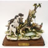 A Capo di Monte porcelain hunting scene,: of pheasants and gun dogs around a tree stump.