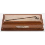 A Garrard & Co silver golf trophy in the form of a putter and ball, on a wooden plinth,