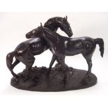 A 20th century bronze model of a mare and stallion,: unsigned on a naturalistic oval base, 52cm.