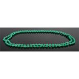 Necklace, with a row of green beads to the strung necklace, 128cm long