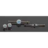 Two brooches, to include a blue topaz example on a bar brooch and a conforming pair of earrings, the