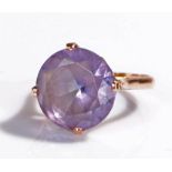 Yellow metal ring with centrally set purple stone