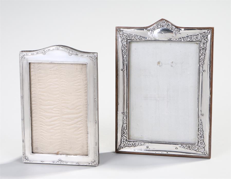 Two silver frames, the first Chester 1915 with an arch to the top and foliate swag decoration,