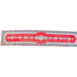 Kerman Persian runner, the red field with a trailing cream medallion, geometric blue ground