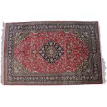 Persian silk rug, the blue medallion with a pink field and acanthus leaf swags and multiple borders,