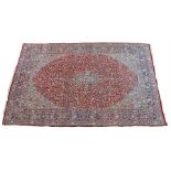 Large Persian carpet, the blue medallion with red field filled with flowers and a border edge, 492cm