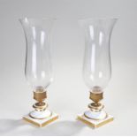 Pair of Victorian candle lamps, the shaped glass shades above a gilt metal collar and porcelain